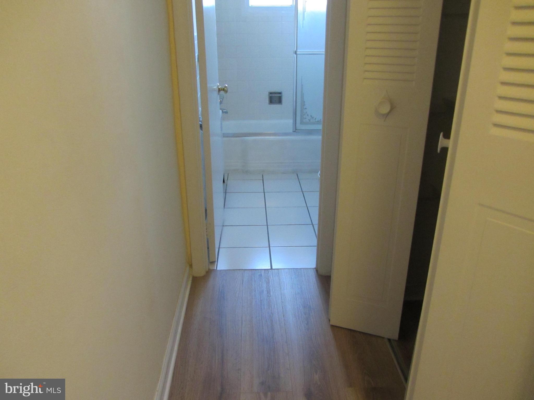 614 Sligo Avenue, Unit 303 Silver Spring, MD 20910 - Photo 18 of 31 a view of a hallway with wooden floor