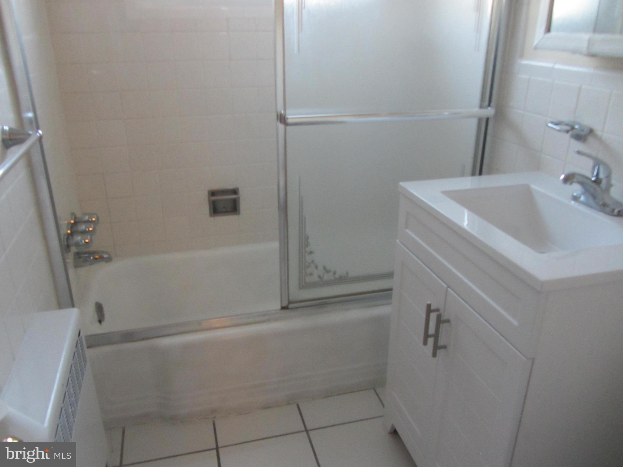 614 Sligo Avenue, Unit 303 Silver Spring, MD 20910 - Photo 21 of 31 a bathroom with a sink and shower