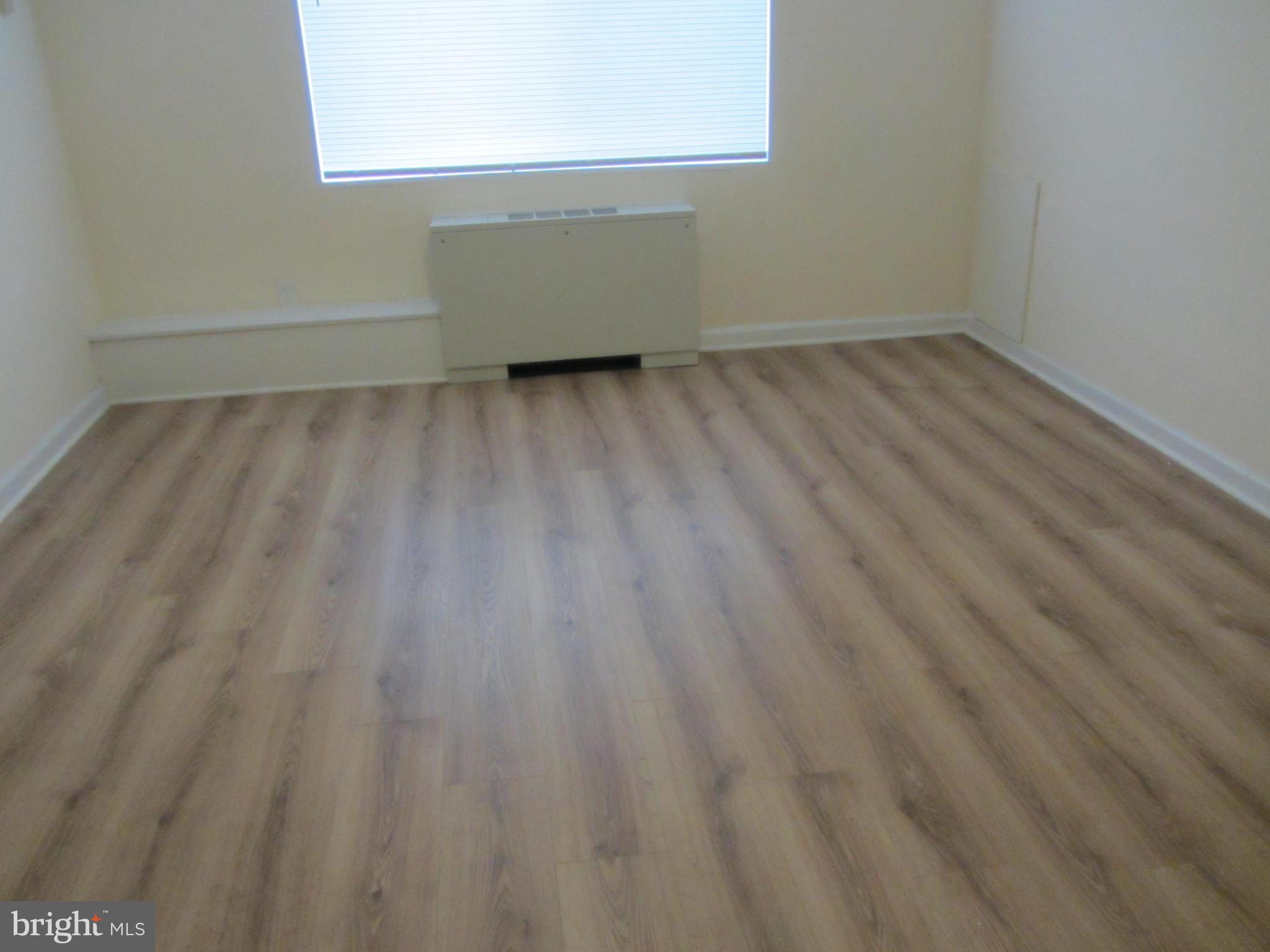 614 Sligo Avenue, Unit 303 Silver Spring, MD 20910 - Photo 22 of 31 a view of a room with wooden floor and a window