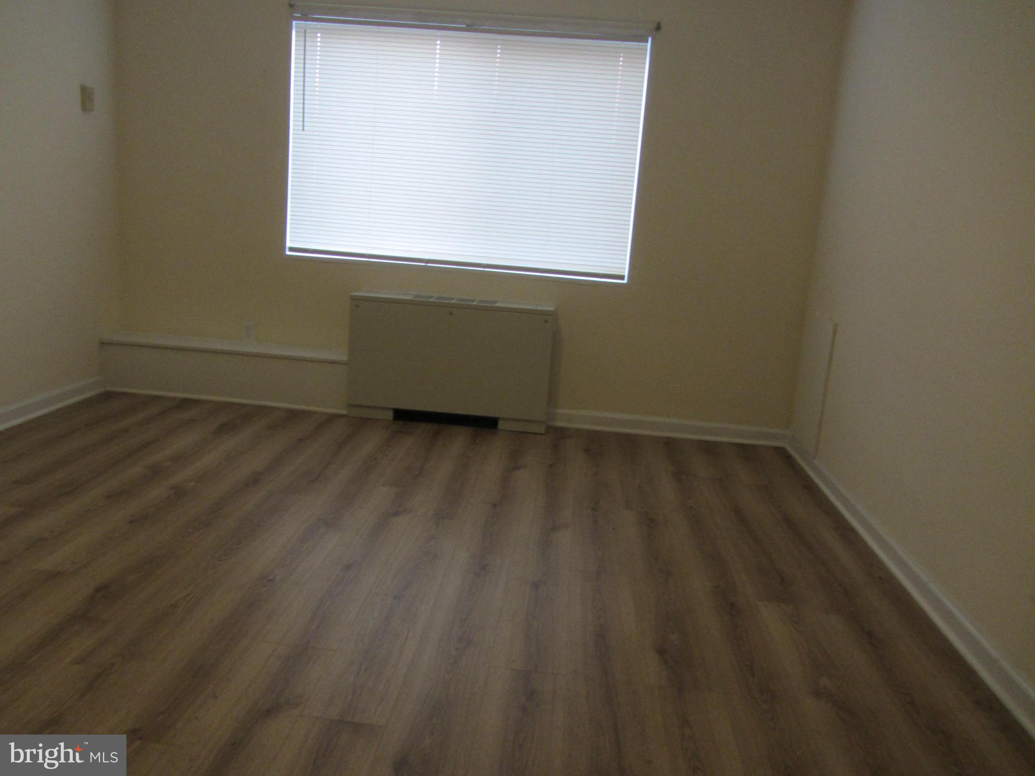 614 Sligo Avenue, Unit 303 Silver Spring, MD 20910 - Photo 29 of 31 a view of a room that has wooden floor and a window