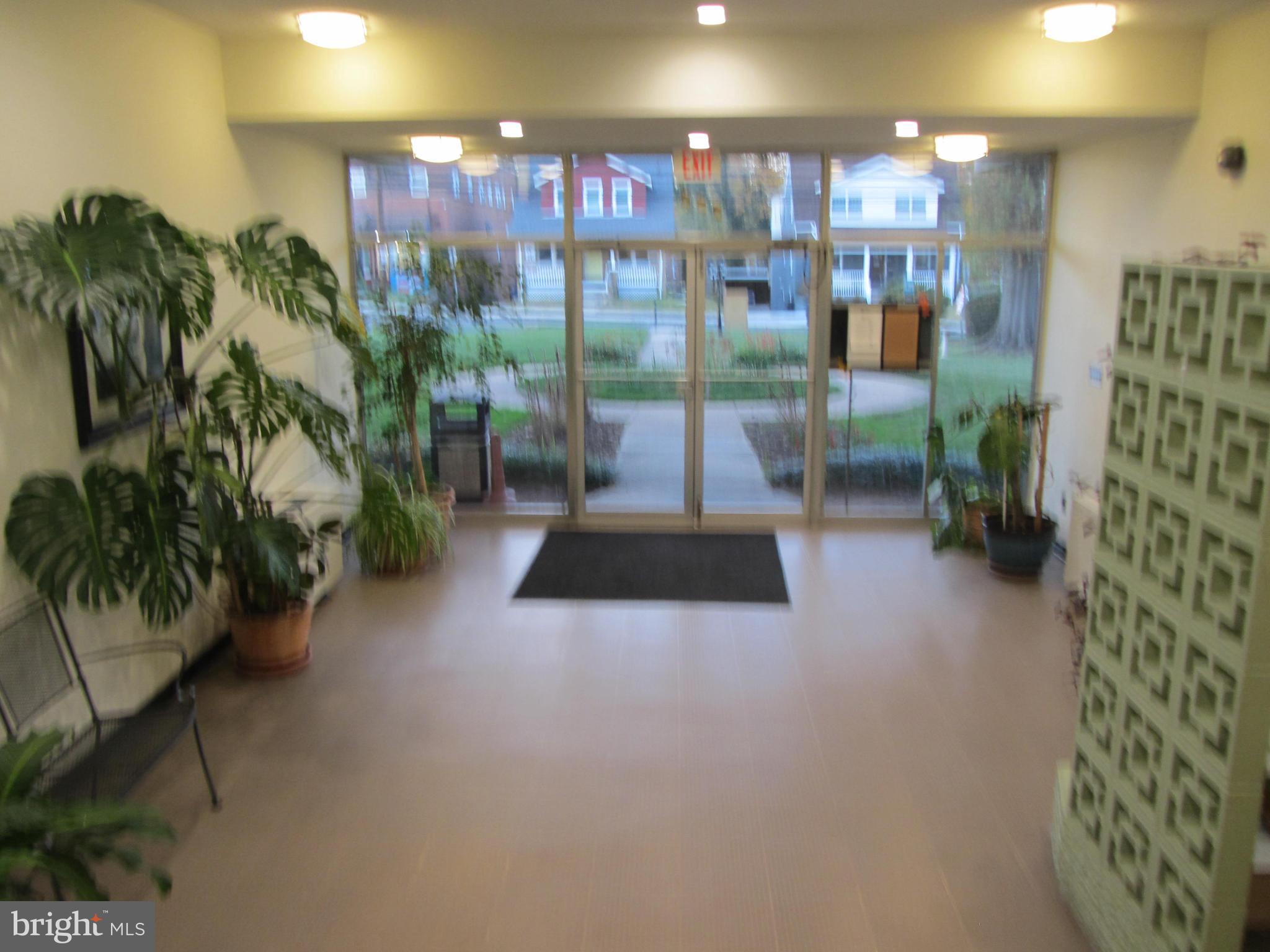 614 Sligo Avenue, Unit 303 Silver Spring, MD 20910 - Photo 4 of 31 a lobby with furniture and potted plant