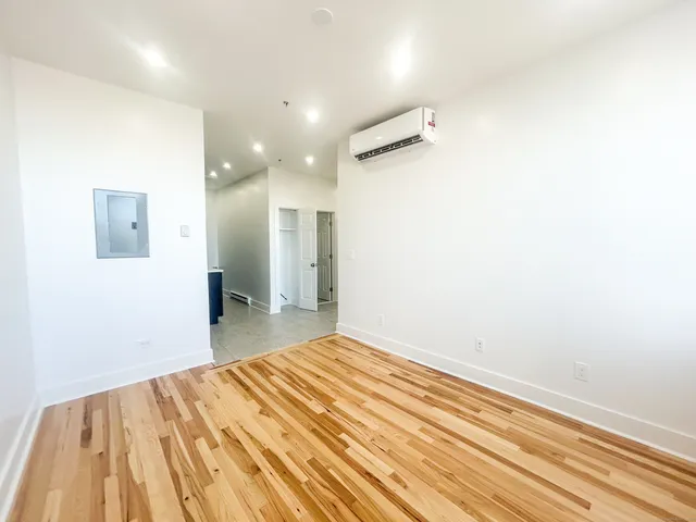 a bedroom with a bed and a mirror