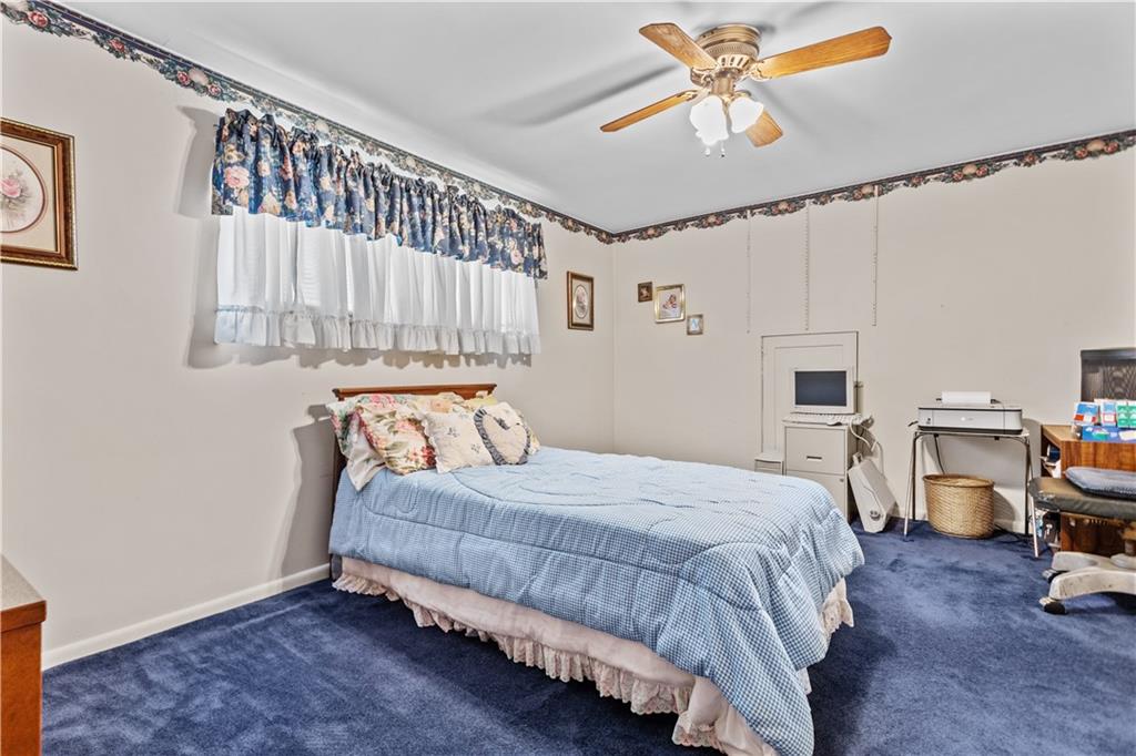 153 George Street Rochester, PA 15074 - Photo 11 of 25 a bedroom with a bed and a chandelier