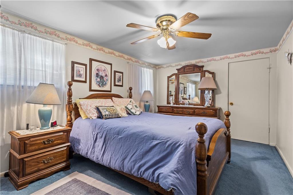 153 George Street Rochester, PA 15074 - Photo 13 of 25 a bedroom with a bed and a chandelier