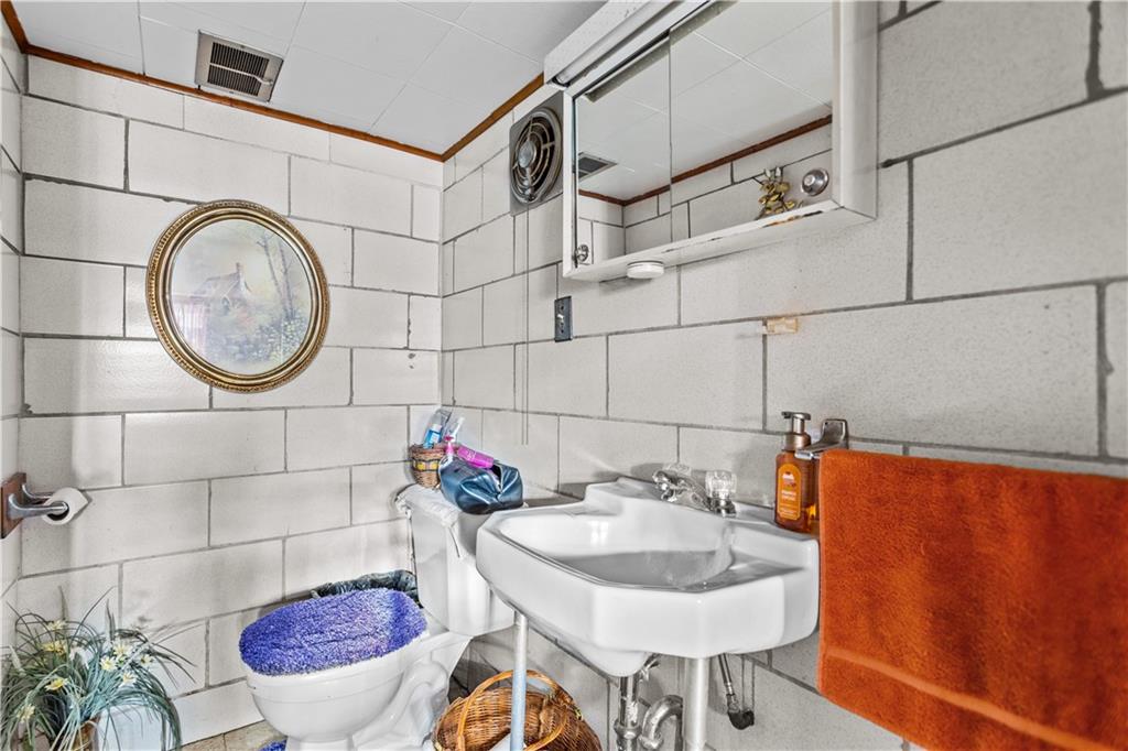 153 George Street Rochester, PA 15074 - Photo 18 of 25 a bathroom with a sink and a mirror