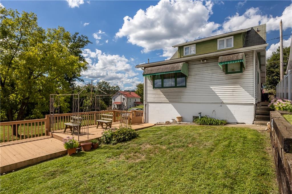 153 George Street Rochester, PA 15074 - Photo 23 of 25 a view of backyard with a garden and bench