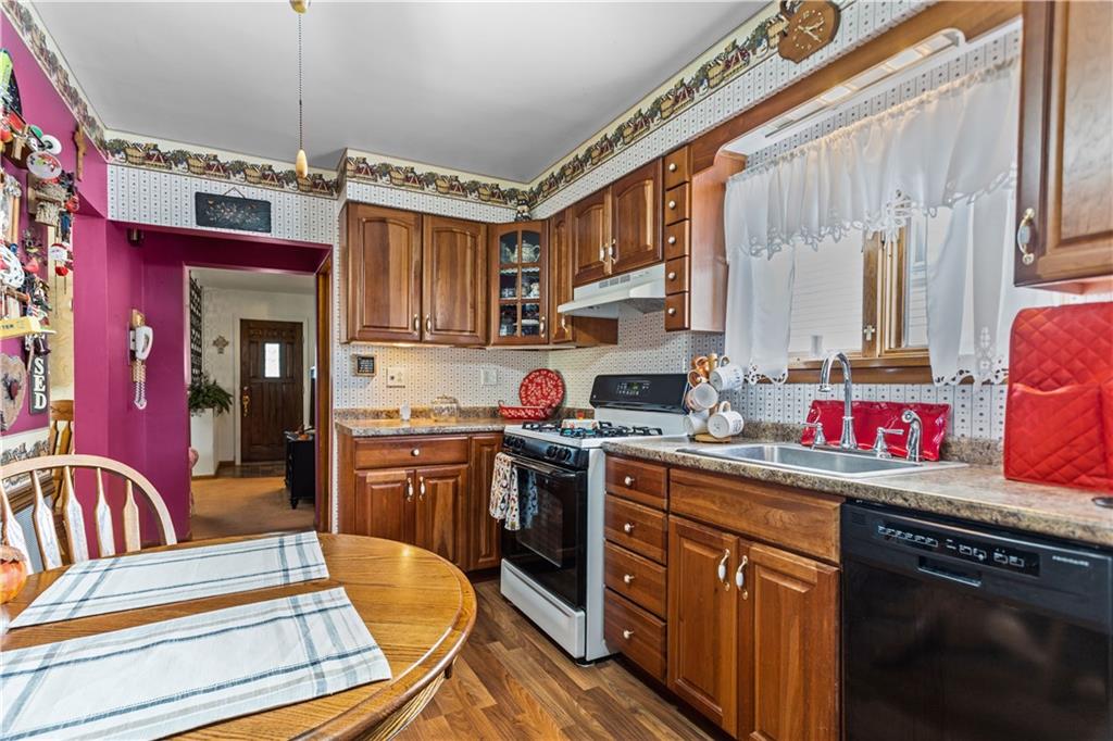 153 George Street Rochester, PA 15074 - Photo 6 of 25 a kitchen with stainless steel appliances granite countertop a stove a sink dishwasher and cabinets with wooden floor
