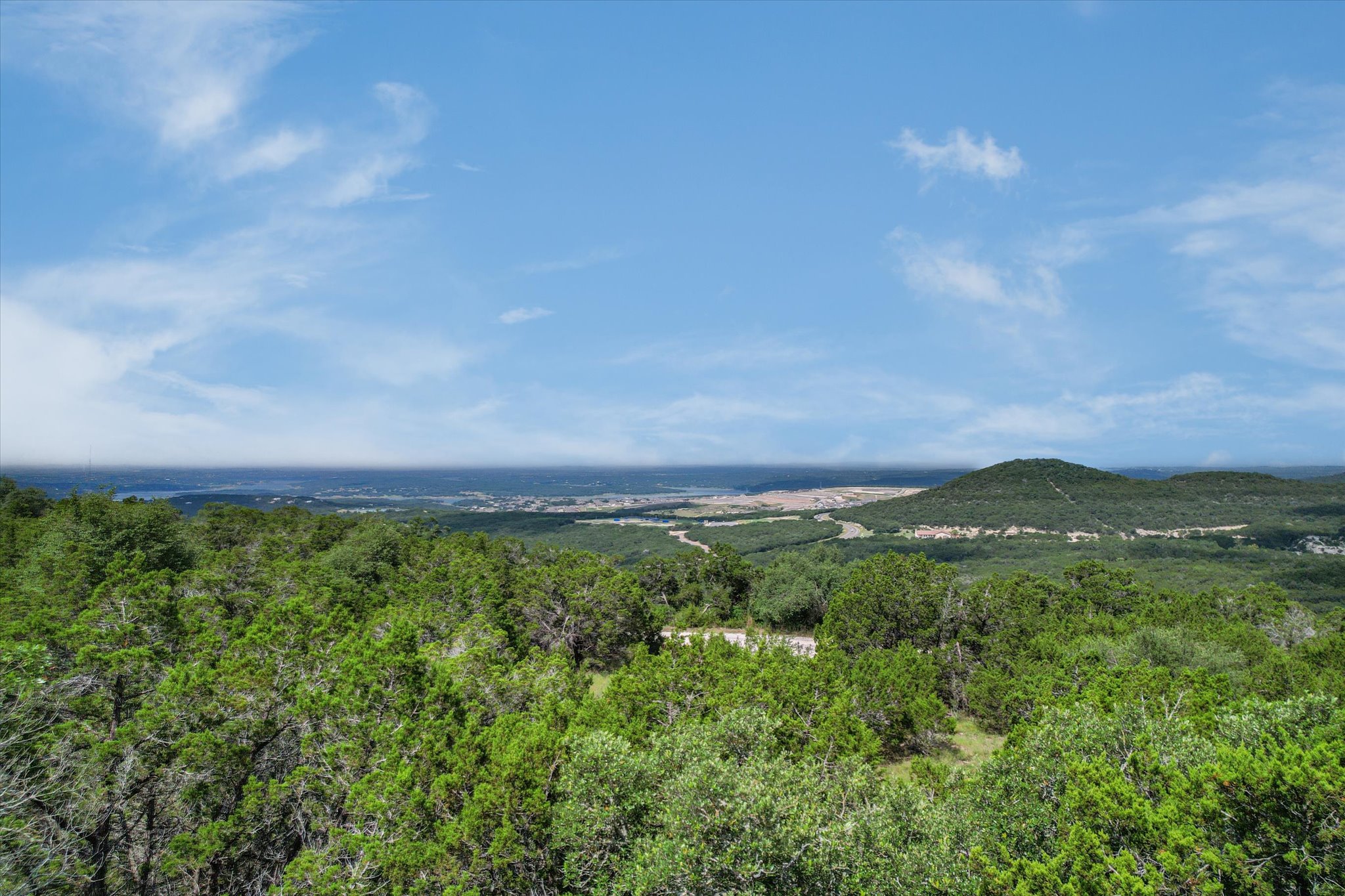 9404 Bar K Ranch Road Leander, TX 78645 - Photo 6 of 12 Capture the natural beauty of the expansive green landscape with sweeping views.