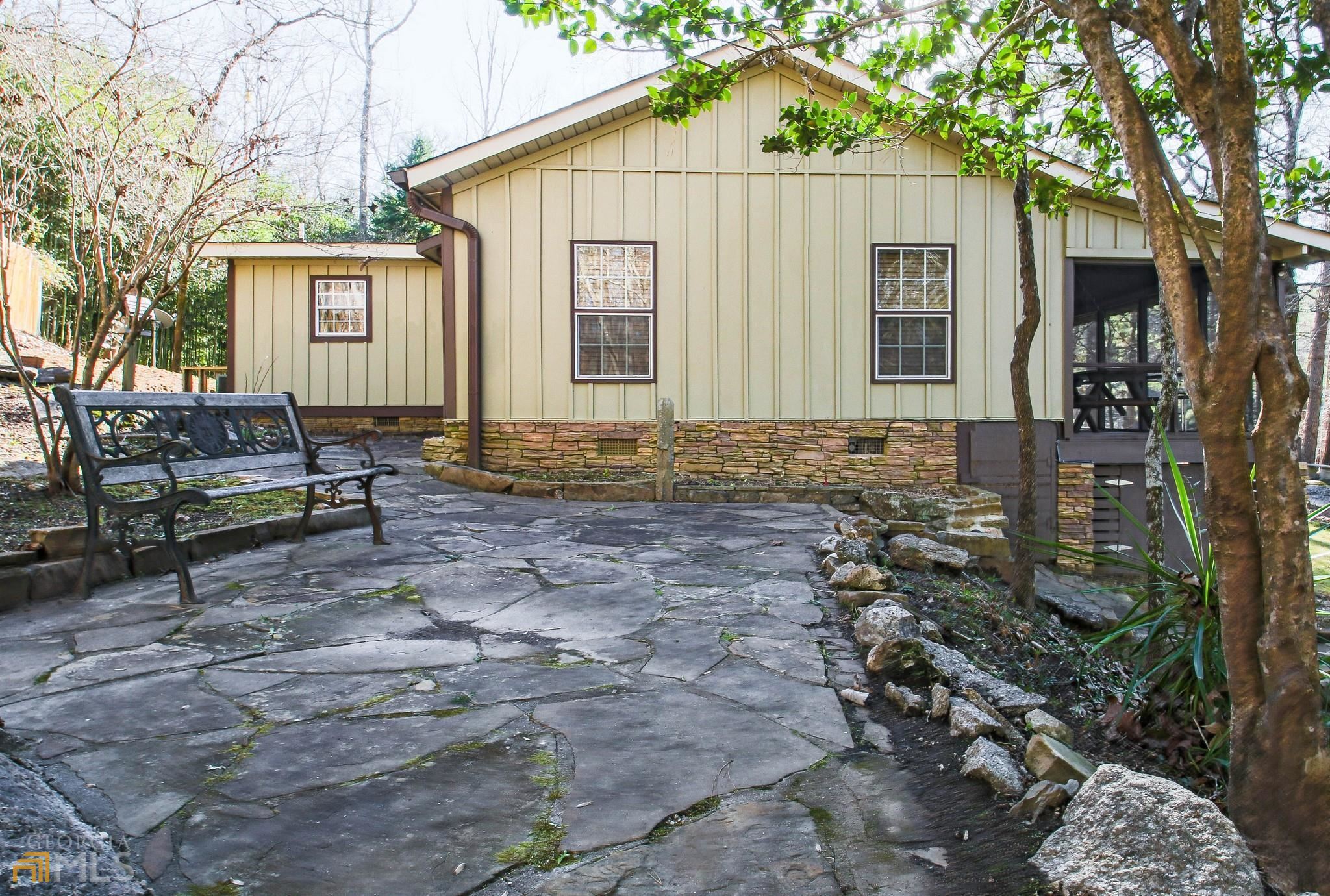 a view of a house with backyard and a tree