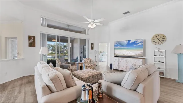 a living room with furniture and a floor to ceiling window