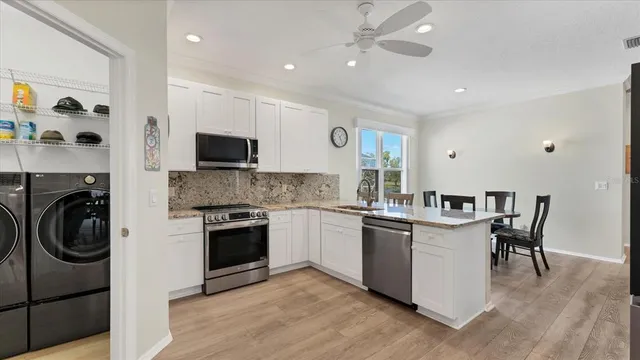 a kitchen with stainless steel appliances granite countertop a stove and a sink