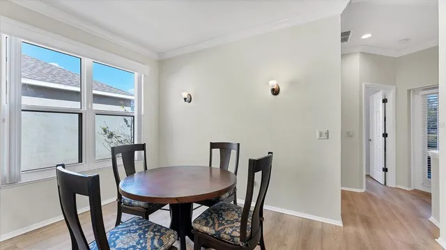 a view of a dining room with furniture and window