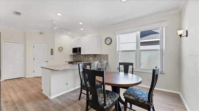 a kitchen with a dining table and chairs