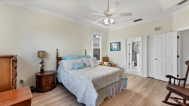 a bedroom with a bed and a chandelier