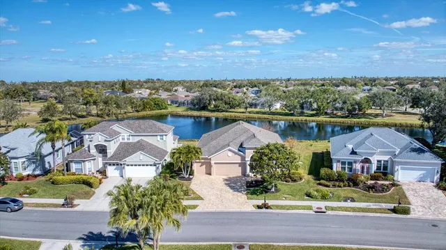 an aerial view of residential houses with outdoor space and ocean view