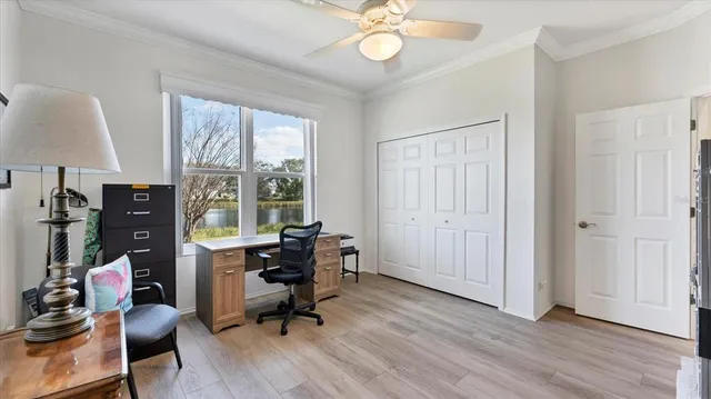 a view of a workspace with furniture and a window