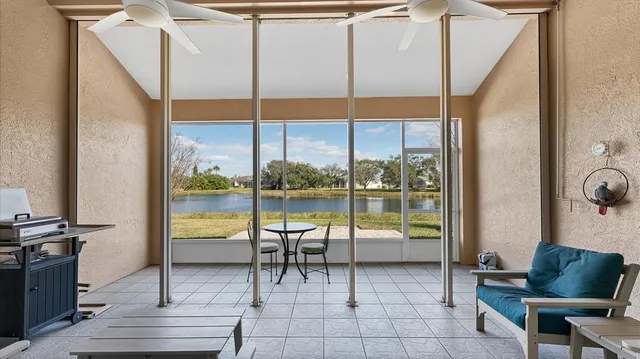 a living room with furniture and a floor to ceiling window