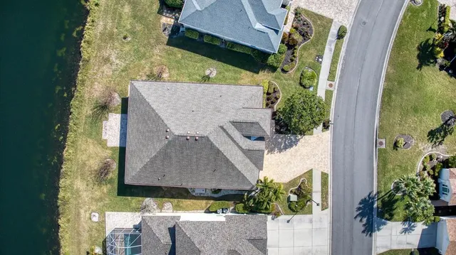 an aerial view of a house with a yard