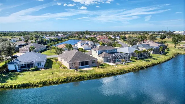 an aerial view of residential houses with outdoor space and swimming pool