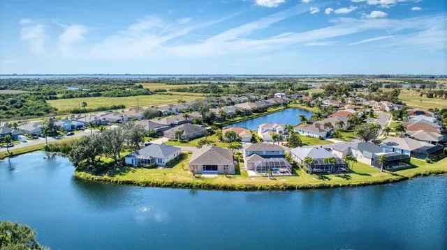 an aerial view of residential houses with outdoor space and swimming pool