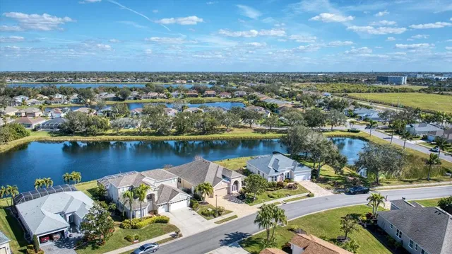 an aerial view of a house with a lake view