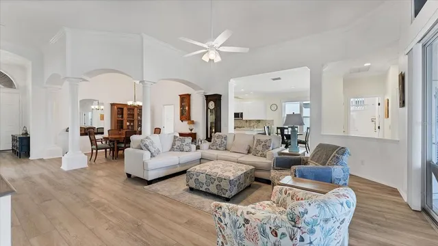 a living room with furniture and a chandelier