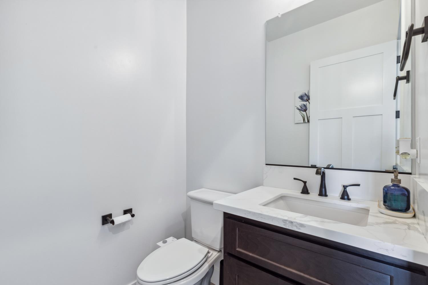 1765 North Renn Avenue Clovis, CA 93619 - Photo 12 of 50 a bathroom with a granite countertop sink a toilet and a mirror
