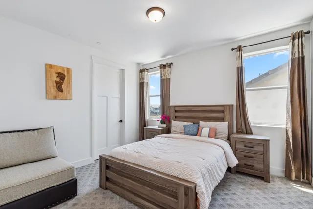 a bedroom with a bed and a couch