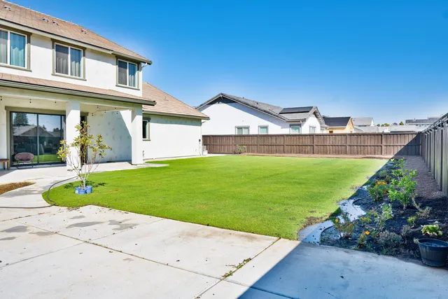 a view of a house with a garden and plants