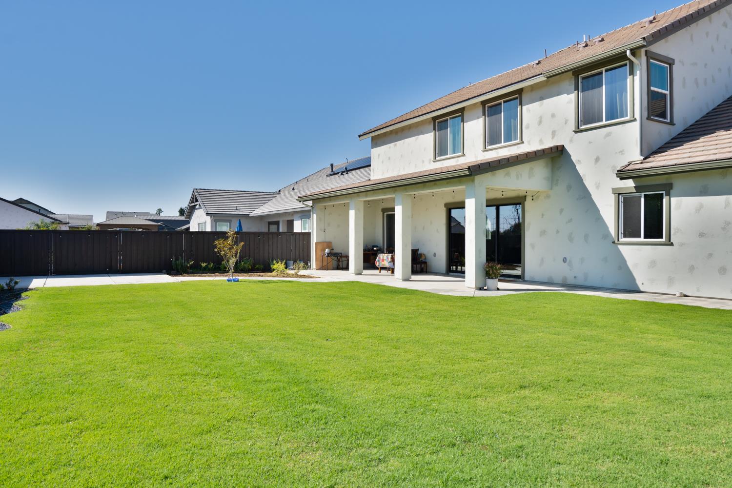 1765 North Renn Avenue Clovis, CA 93619 - Photo 48 of 50 a view of a white house with a big yard and potted plants