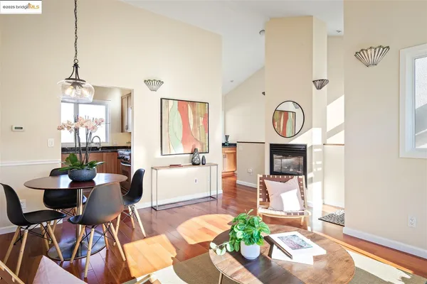 a living room with fireplace furniture and a large window