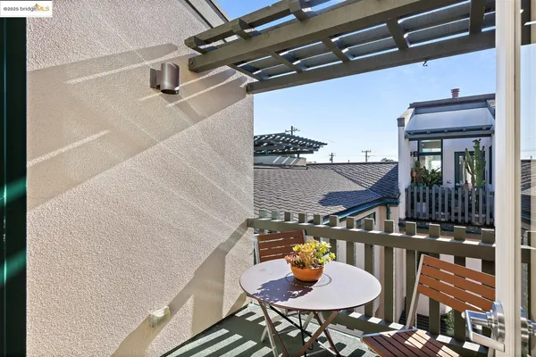 a balcony with table and chairs
