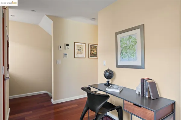 a view of a workspace with furniture and wooden floor