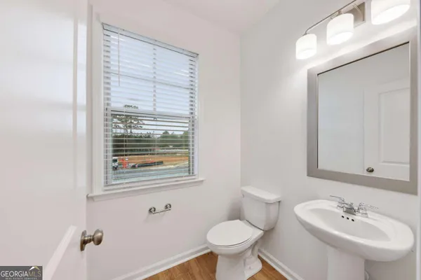 a bathroom with a sink toilet and a mirror