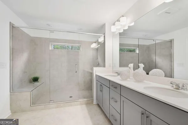 a bathroom with a double vanity sink and mirror