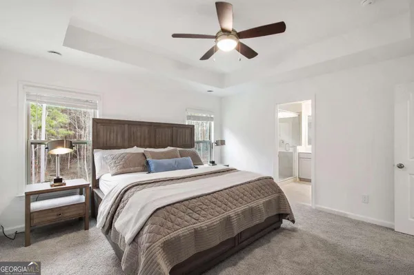 a bedroom with a bed and a chandelier