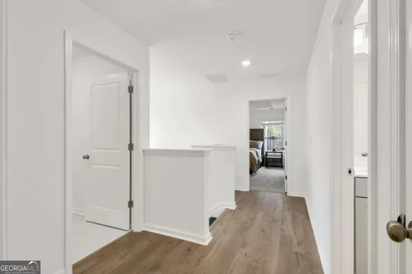 a view of a hallway with wooden floor