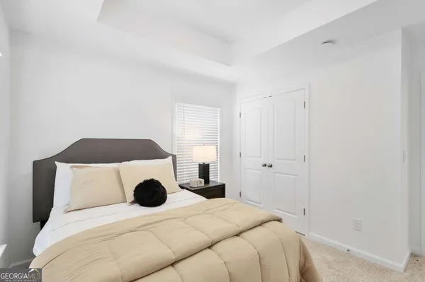 a bedroom with a bed and a large window