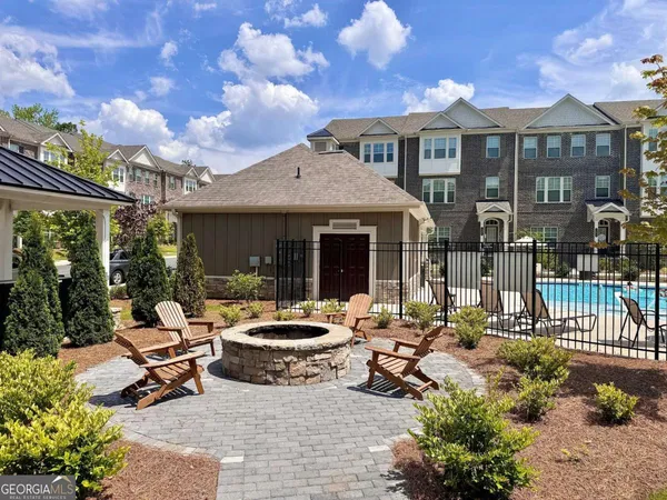 a view of a house with swimming pool and sitting area