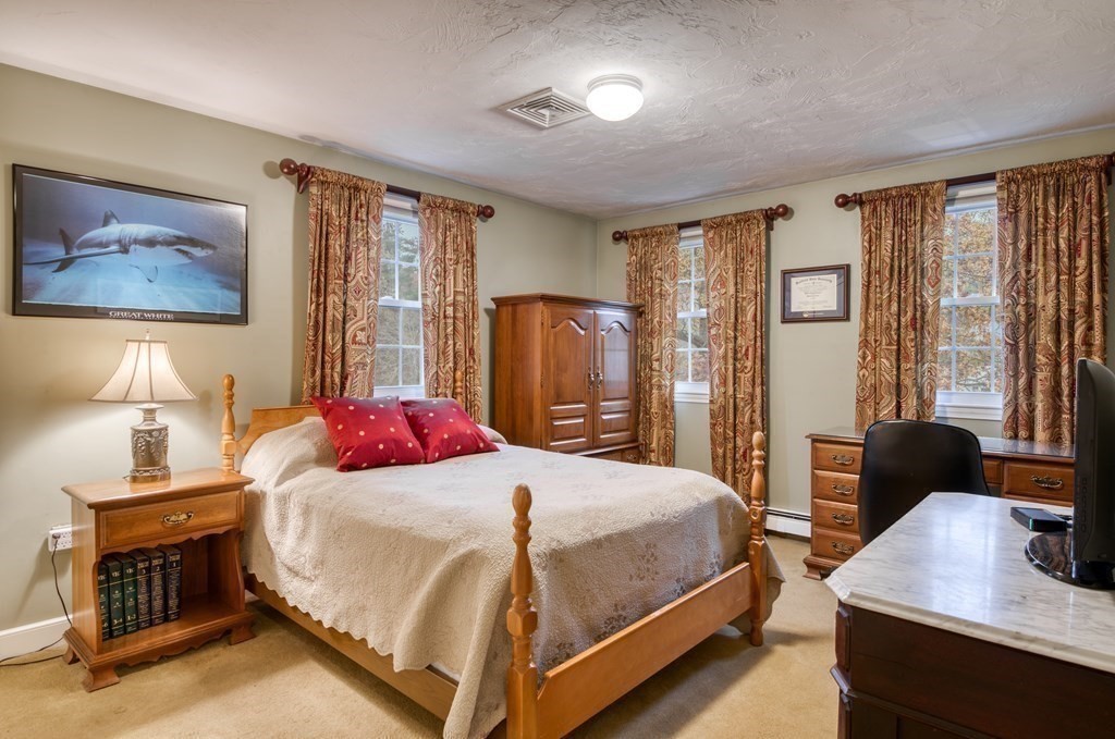 20 Clark Circle Hanover, MA 02339 - Photo 15 of 35 a bedroom with a bed and wooden floor