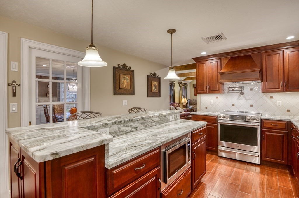 20 Clark Circle Hanover, MA 02339 - Photo 2 of 35 a kitchen with granite countertop kitchen island stainless steel appliances a sink stove and kitchen island