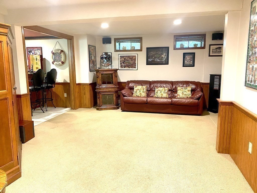 20 Clark Circle Hanover, MA 02339 - Photo 22 of 35 a living room with furniture and a flat screen tv