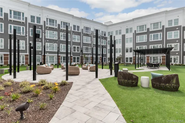 a swimming pool with outdoor seating and a garden