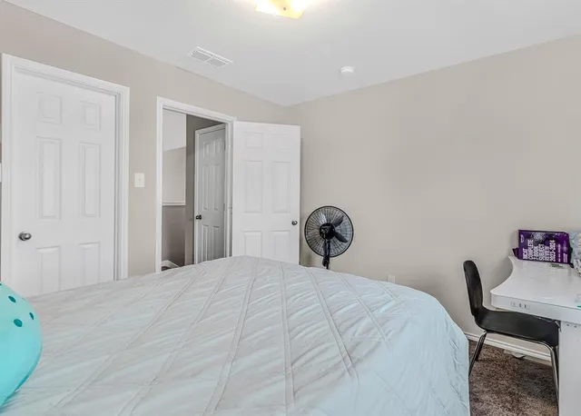 a bedroom with a bed and a table in it