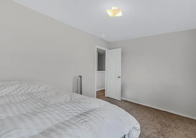 a bedroom with a bed and a night stand