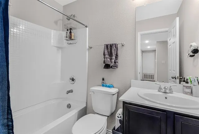 a bathroom with a sink toilet tub and shower