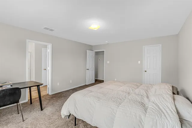 a bedroom with a bed and a table in it