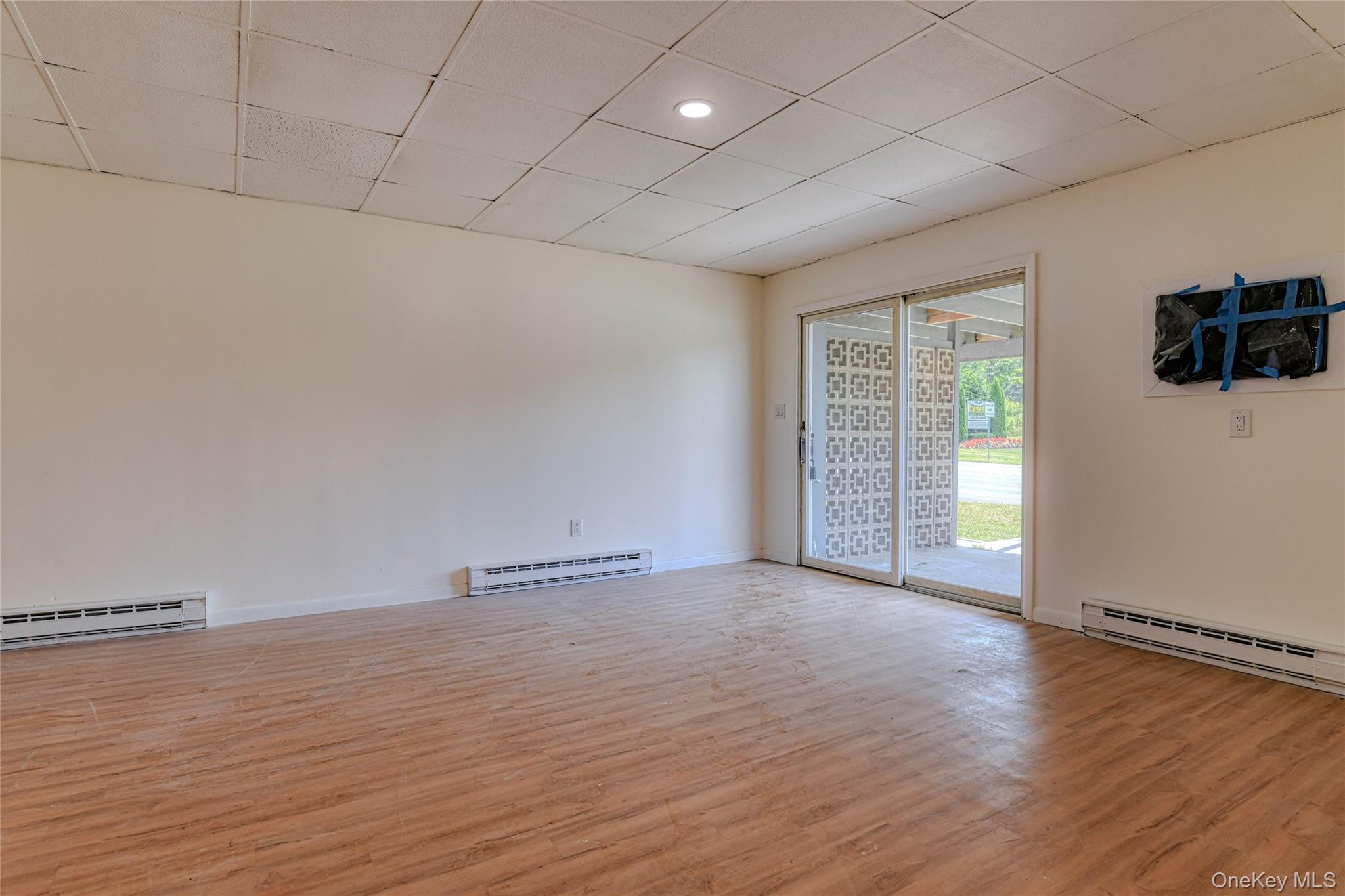 1614 Rte 9W, Unit 3 Milton, NY 12547 - Photo 3 of 13 an empty room with wooden floor and windows