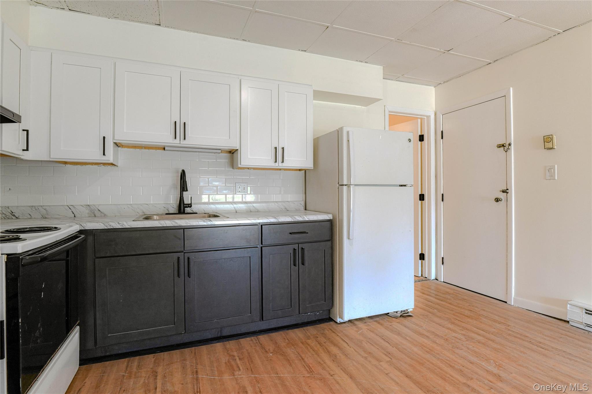 1614 Rte 9W, Unit 3 Milton, NY 12547 - Photo 5 of 13 a kitchen with stainless steel appliances granite countertop a refrigerator sink and cabinets
