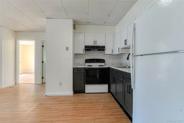 a kitchen with stainless steel appliances granite countertop a refrigerator and a stove
